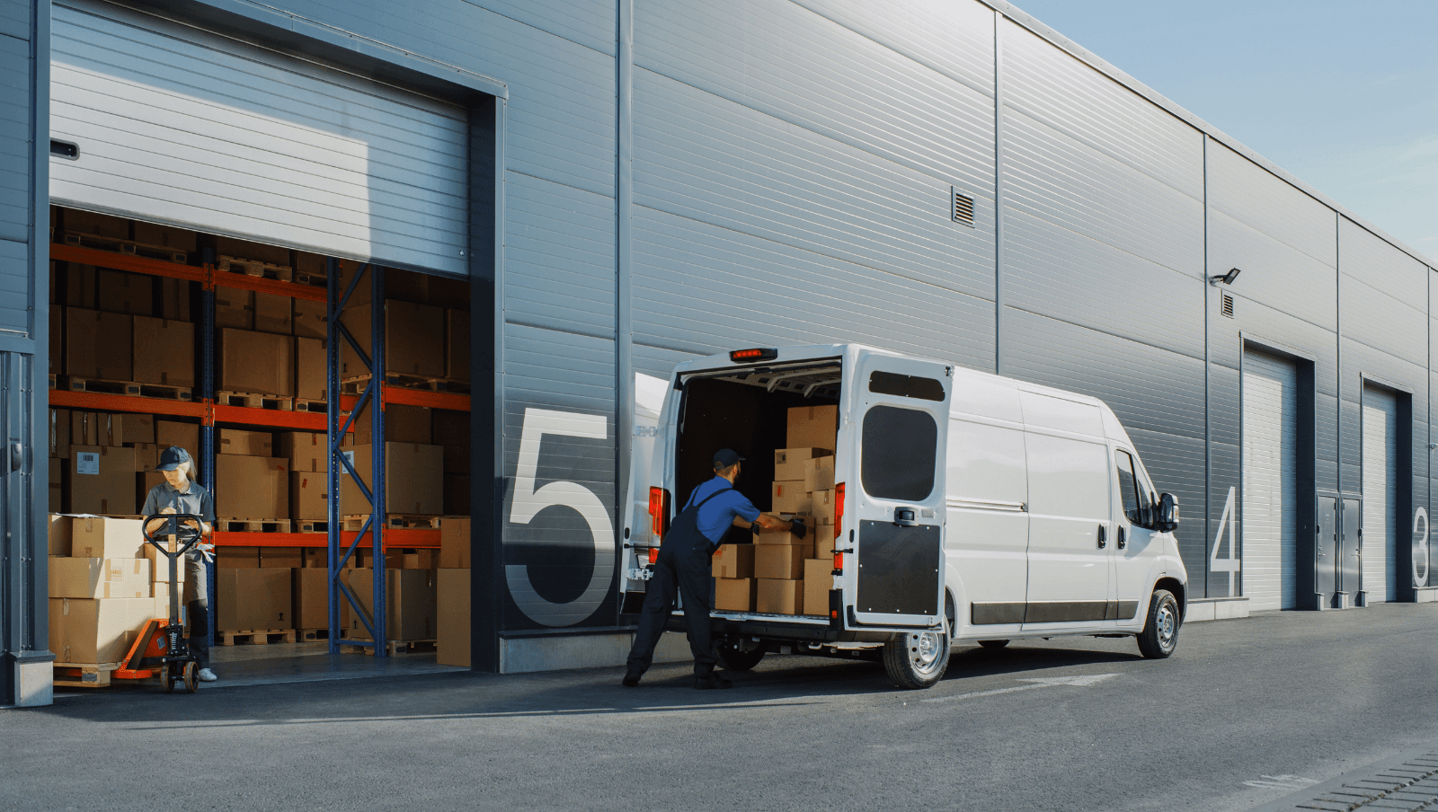 Loading dock with a delivery van and staff moving boxed stock